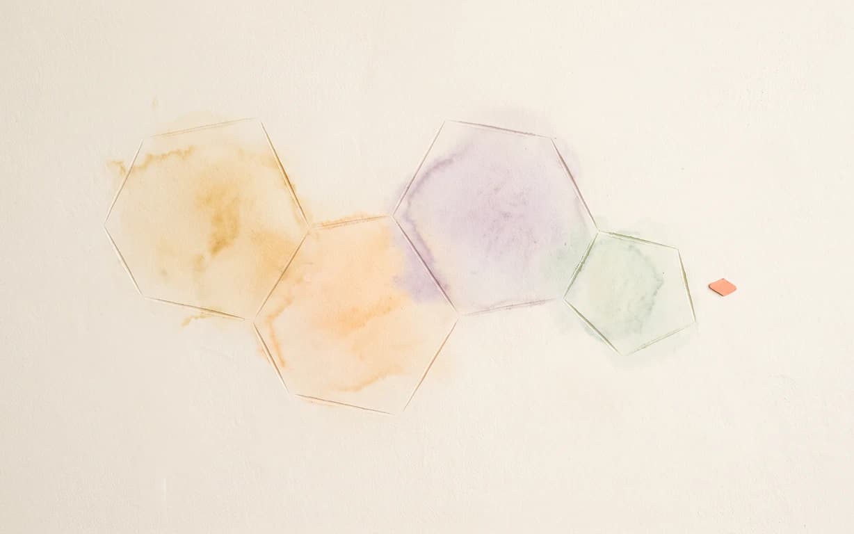 Four fused amber, apricot, lavender and celadon ring outlines form a flat steroid-like pattern on warm-ivory plaster beside a tiny coral diamond.