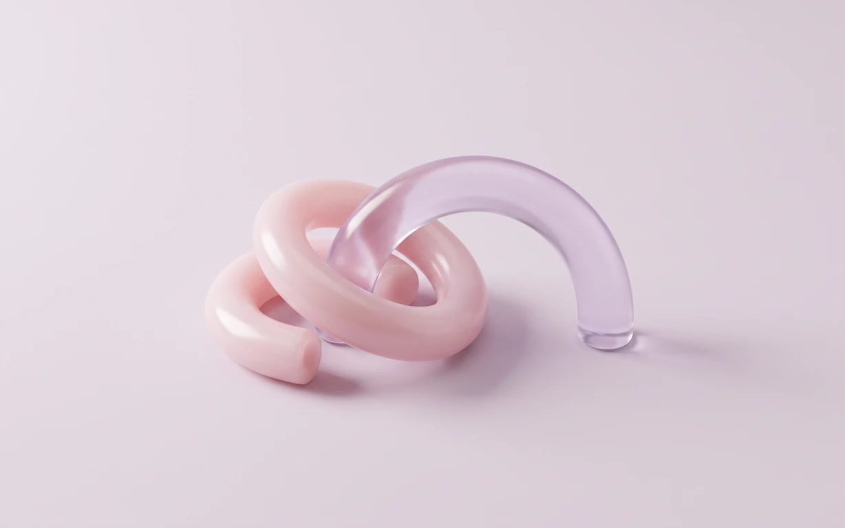 Intertwined glossy blush-pink and translucent lilac sculptural loops resting on a pale seamless surface with soft shadows.